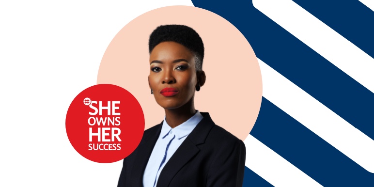 A young mixed-raced woman with red lipstick wearing a white shirt and posing against a #SheOwnsHerSuccesss branded background, looking determined to forge her own path to success.